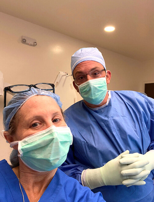 Bunion Surgeons Dr. Jodi Schoenhaus, DPM, and Dr. Jason Gold, DPM, posing in a photo before entering the surgical room in Boca Raton, FL.