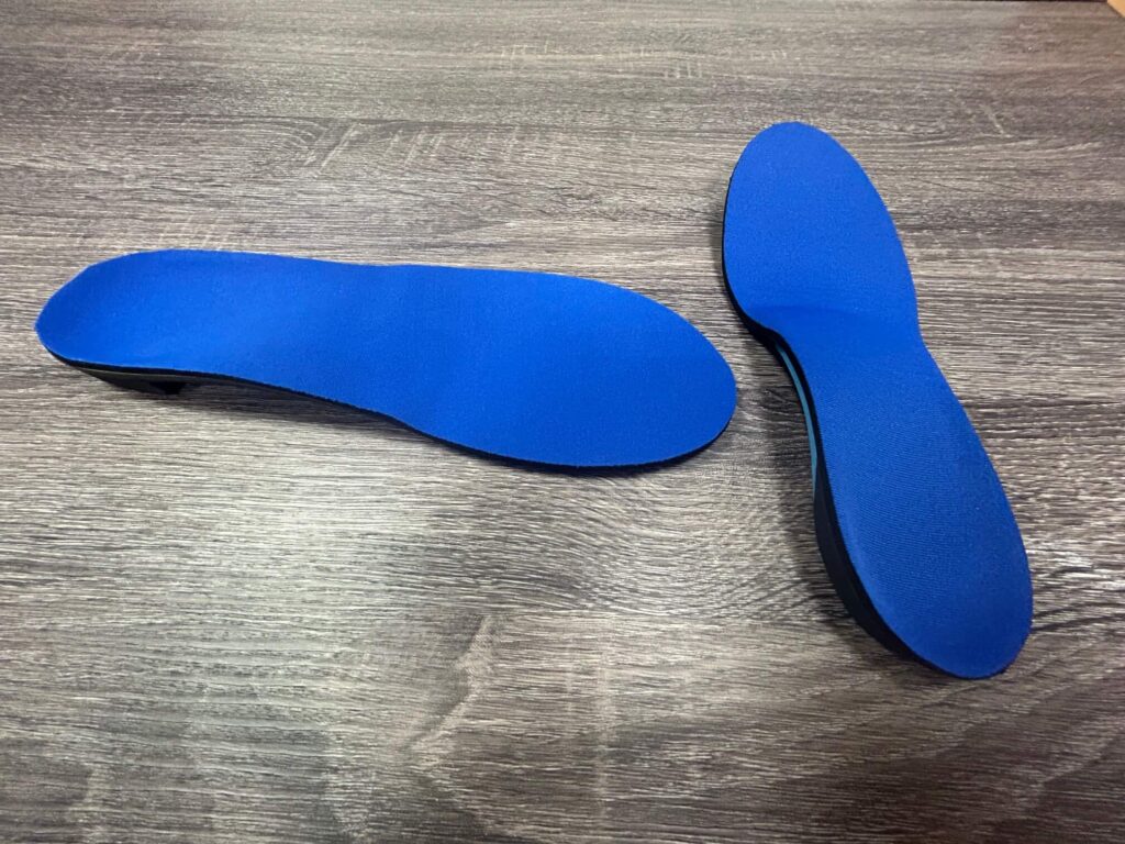 An image of a custom orthotic mold with a foot impression in blue material is used as a conservative care option for bunions from the Foot, Ankle & Leg Vein Center.